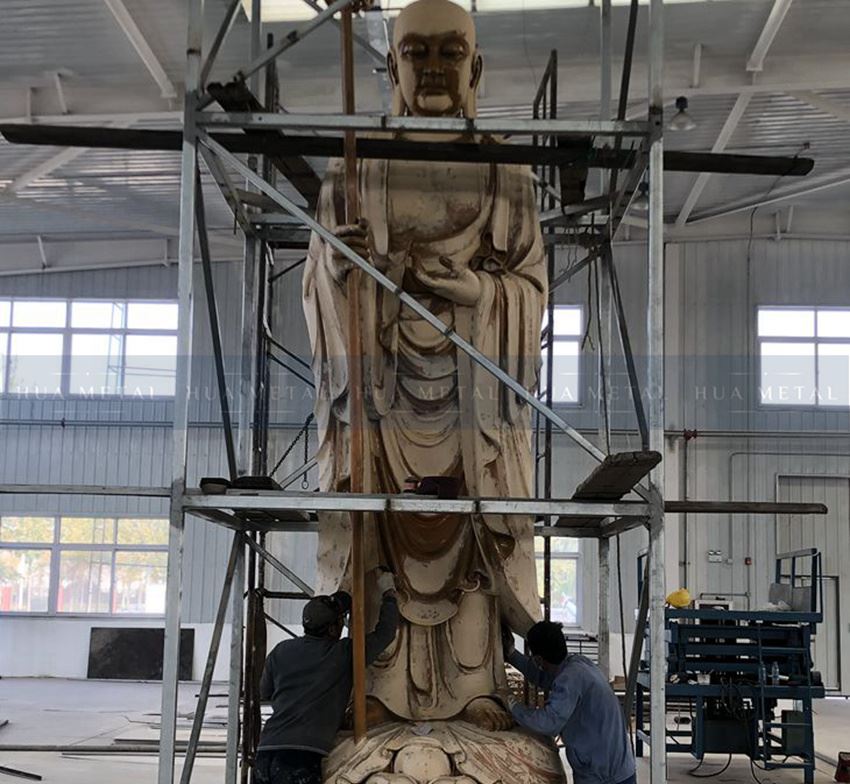 puttying on bronze buddha statue sculpture